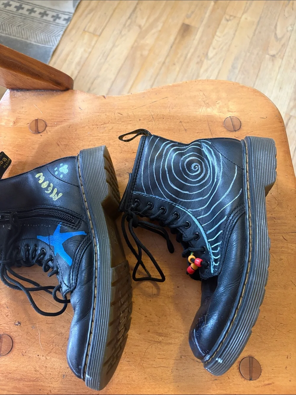 Dr. Martens Black Leather Unisex Kids Lace-Up Boots with Original Paint Artwork